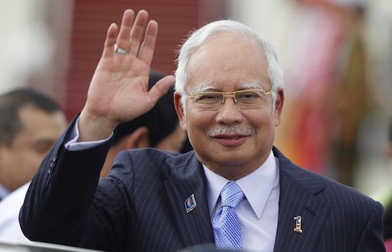Malaysia's Prime Minister Najib Razak waves as he arrives at Naypyitaw international airport to attend 24th ASEAN Summit